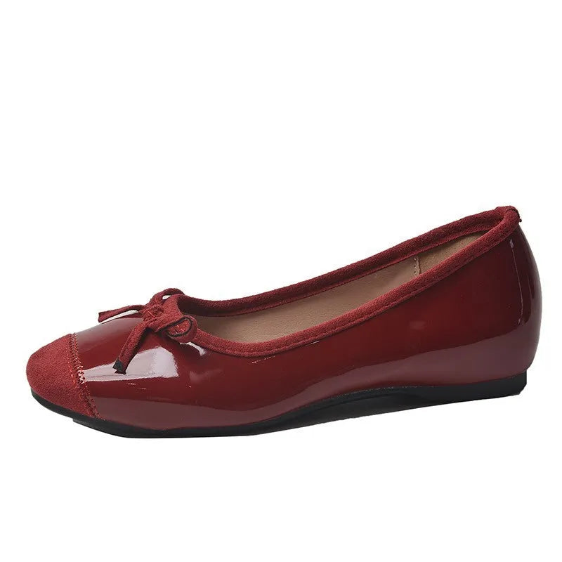 Women's wine red Mary Jane flats with square toe, decorative bow, and a low rubber sole.