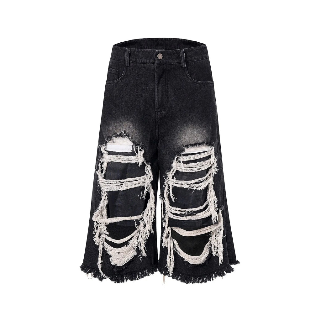 Women's black cropped wide-leg jeans with distressed patch details and mid-high waist