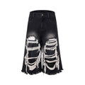 Women's black cropped wide-leg jeans with distressed patch details and mid-high waist