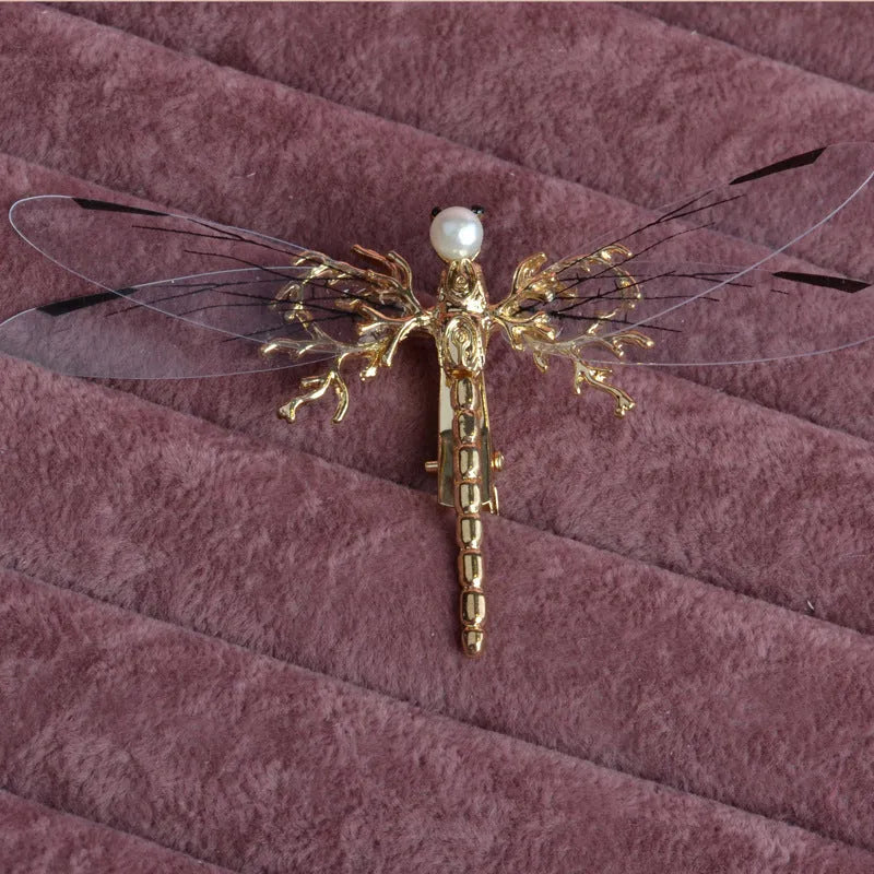Golden dragonfly-shaped women's hair clip made from alloy with a side fastening.