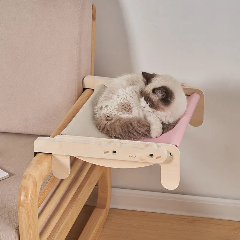 Solid wood pet bed for cats with removable washable cover in black and white plaid pattern on floor