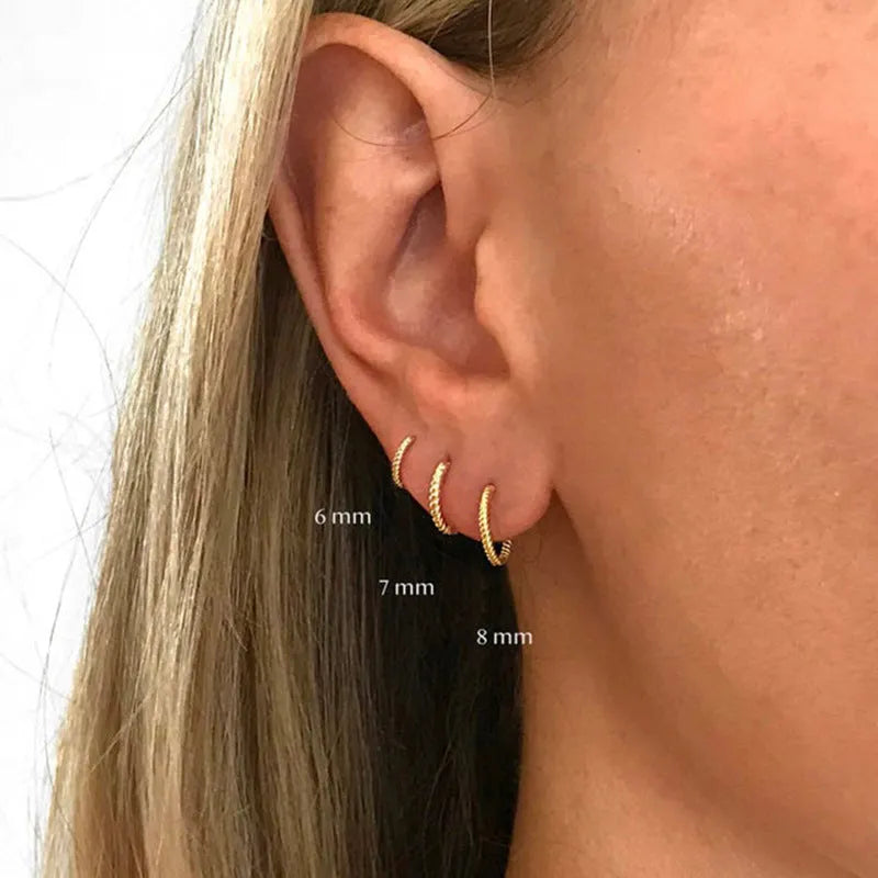 Twisted string round ring earrings in sterling silver with geometric design showing gold and platinum finish options