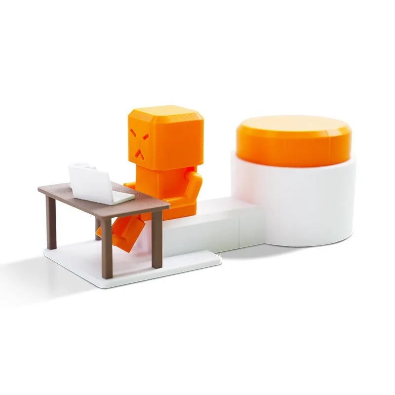 Orange plastic rotating decompression toy on a desk, showing its 16cm length.