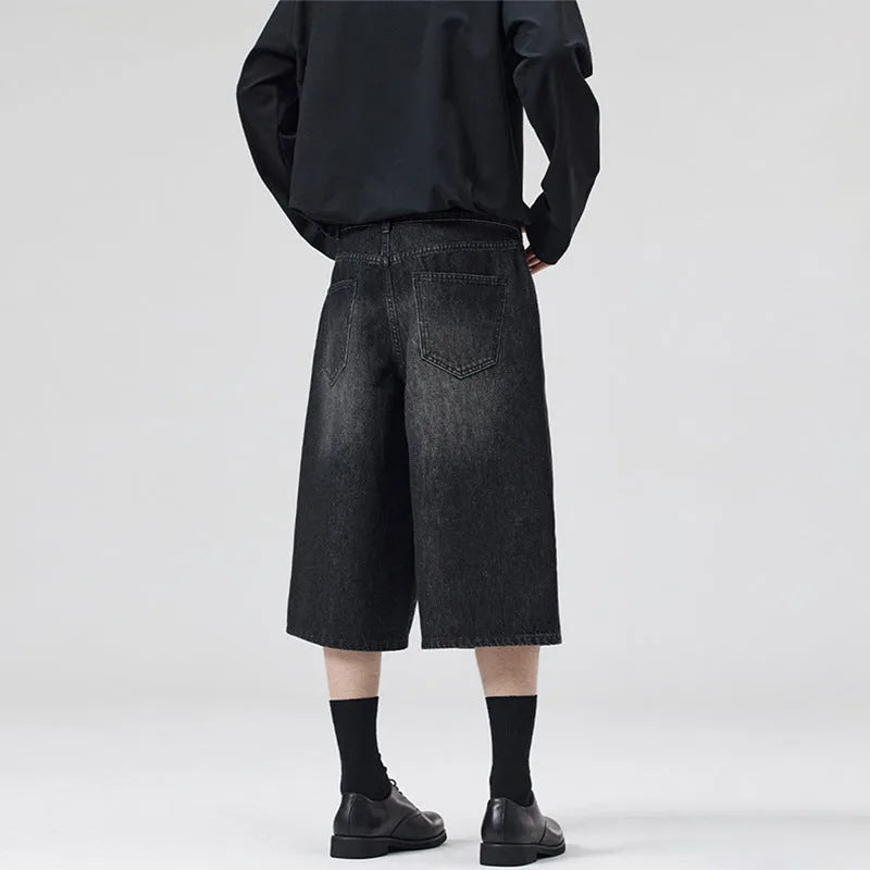 Men's loose straight-leg cropped denim shorts in light blue on a mannequin.