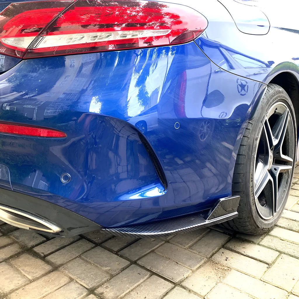 Pair of car rear bumper corner protectors in carbon fibre pattern on a vehicle rear corner