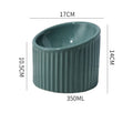Elevated ceramic cat bowl in green, shown at a tilted angle to highlight its raised base and round feeding dish.
