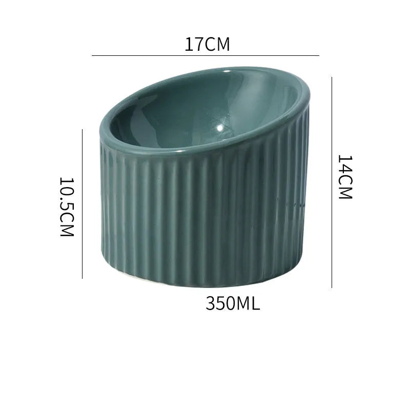 Elevated ceramic cat bowl in green, shown at a tilted angle to highlight its raised base and round feeding dish.