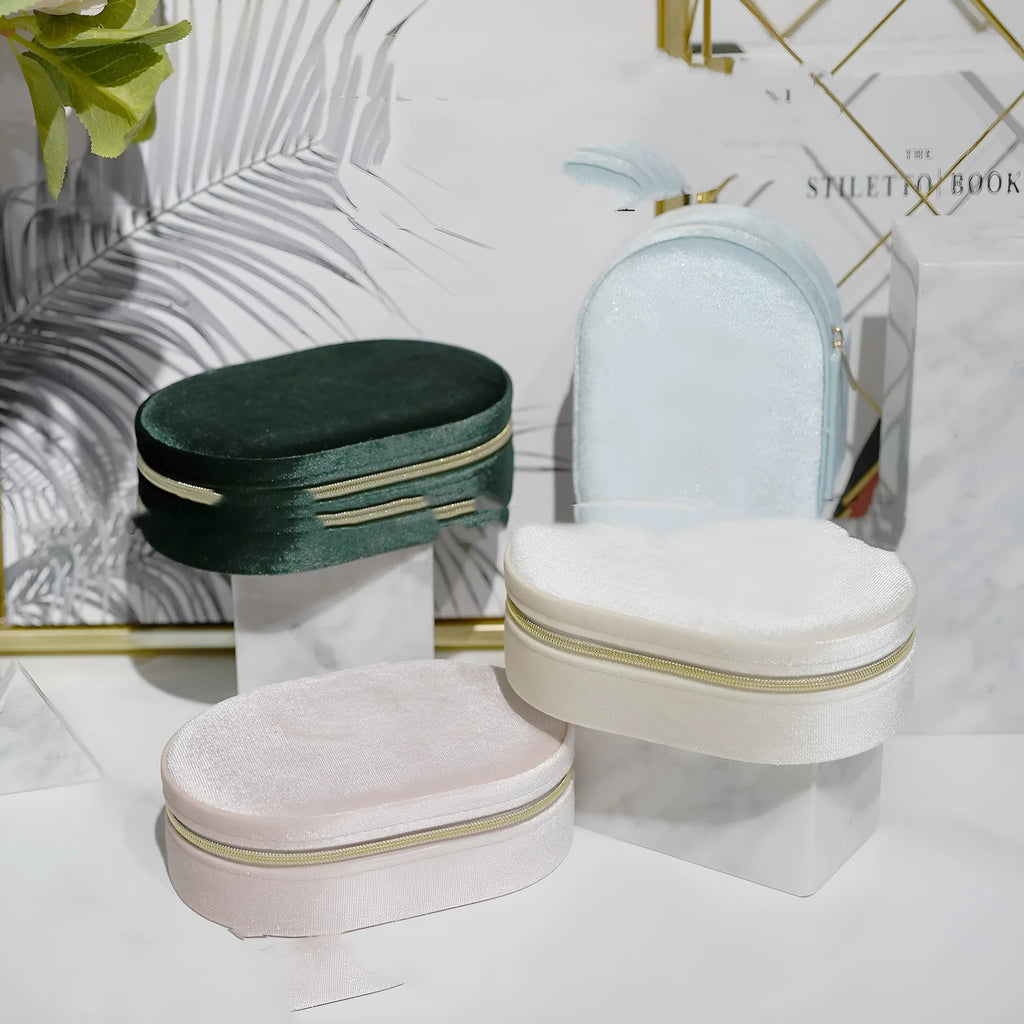 Oval velvet jewellery storage box in assorted colours with flannel lining, showing 15cm by 10cm dimensions.