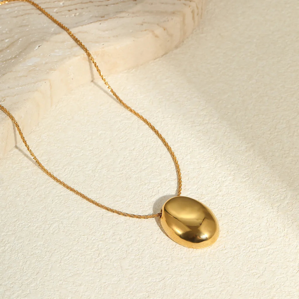 Gold-plated geometric pendant necklace with adjustable chain on model