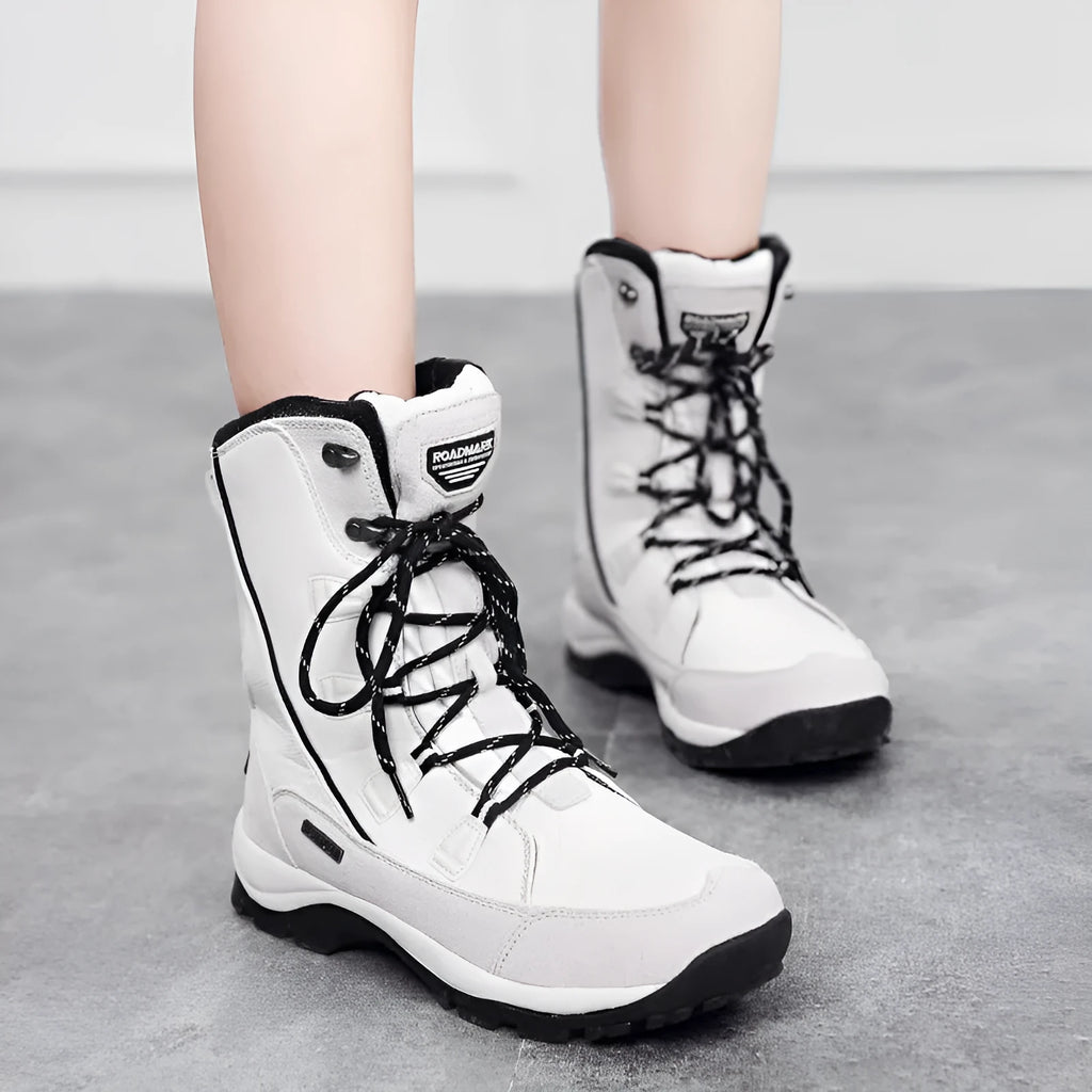 Women's black mid-calf leather snow boot with a textured non-slip rubber sole.