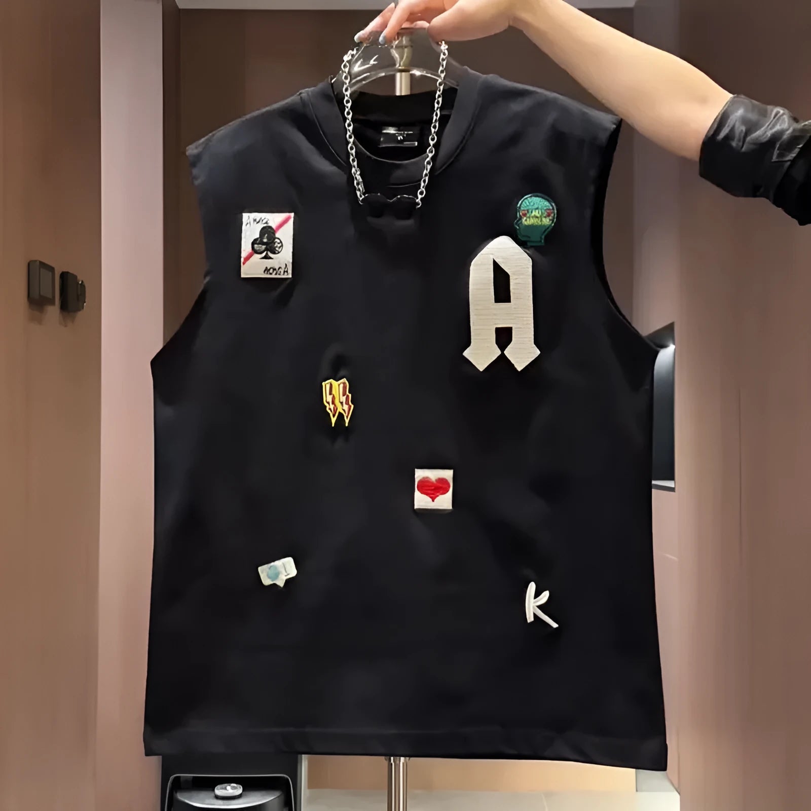 Man's loose-fit cotton sleeveless vest with a cartoon graphic, shown in black and white colour options.