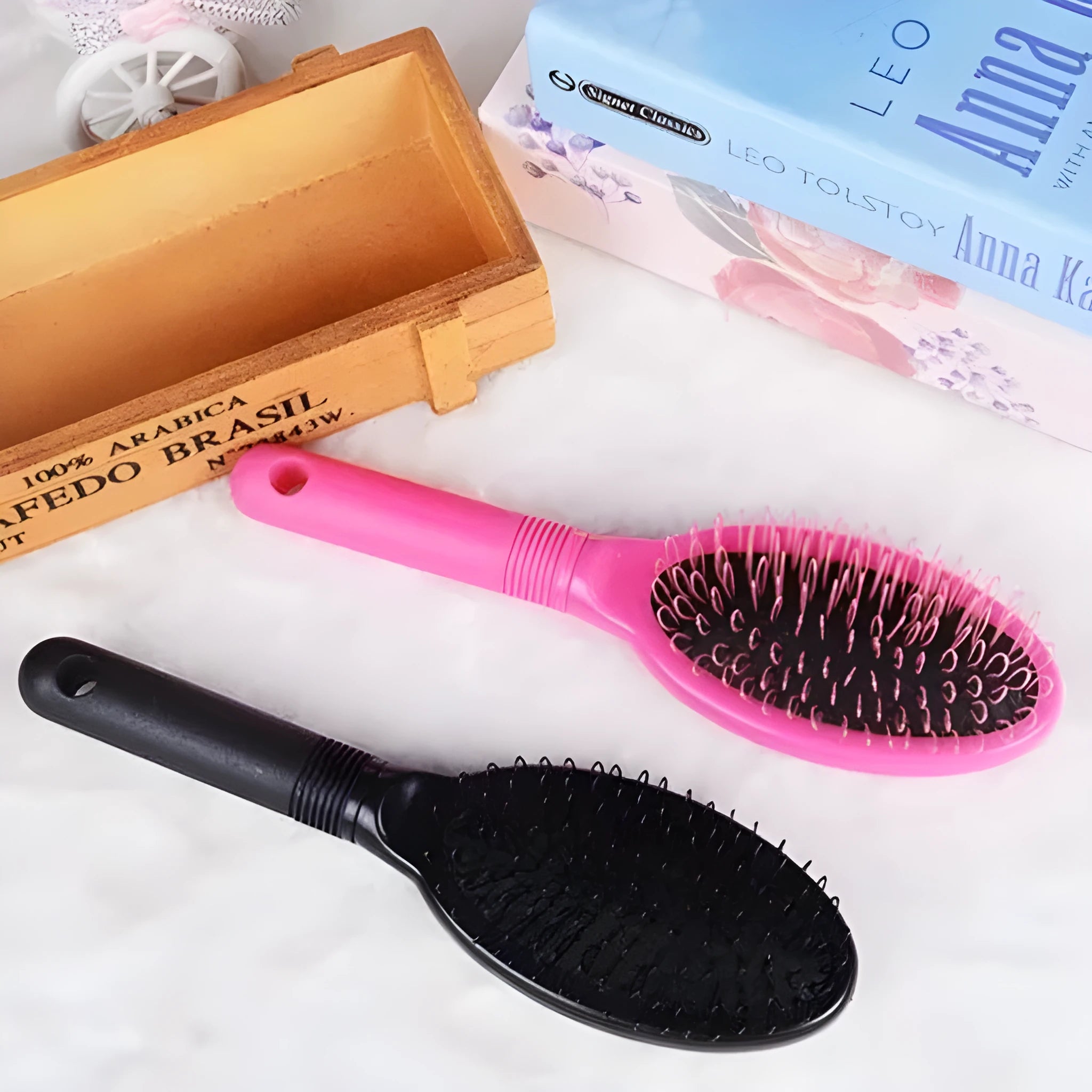 Black ring tooth hair extension comb with airbag cushioning on white background