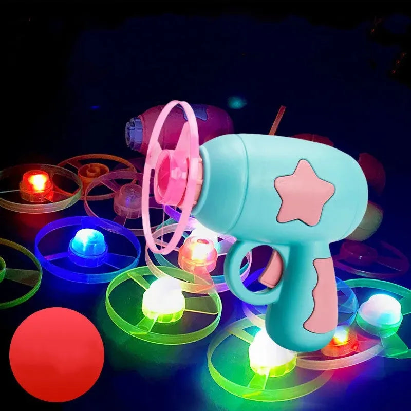 Flying saucer launcher toy set with plastic disc shooter gun, flashing discs, and target board, in blue, navy, pink, and yellow