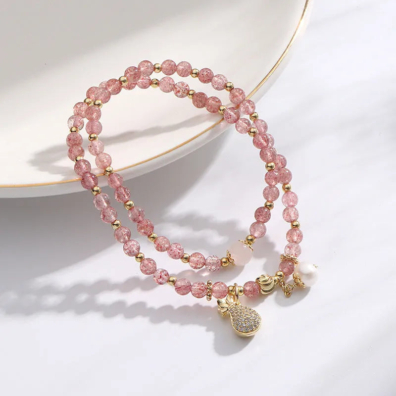 Strawberry quartz crystal bracelet with geometric pink beads on adjustable string
