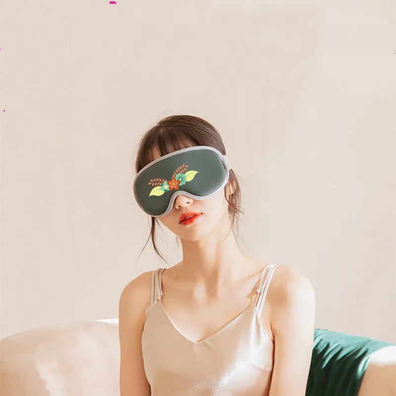 Green portable eye massage mask with suede exterior on a white background.
