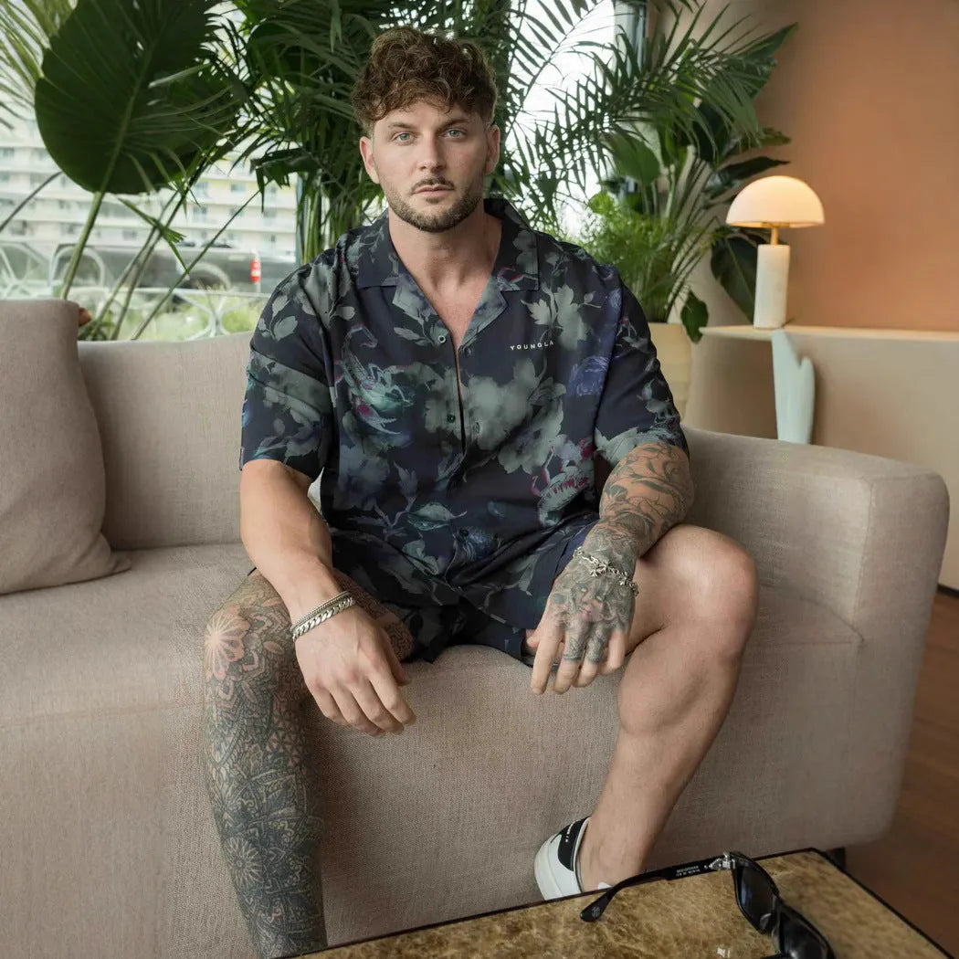 Man wearing a loose-fit, short-sleeve floral print cardigan in a light colour.