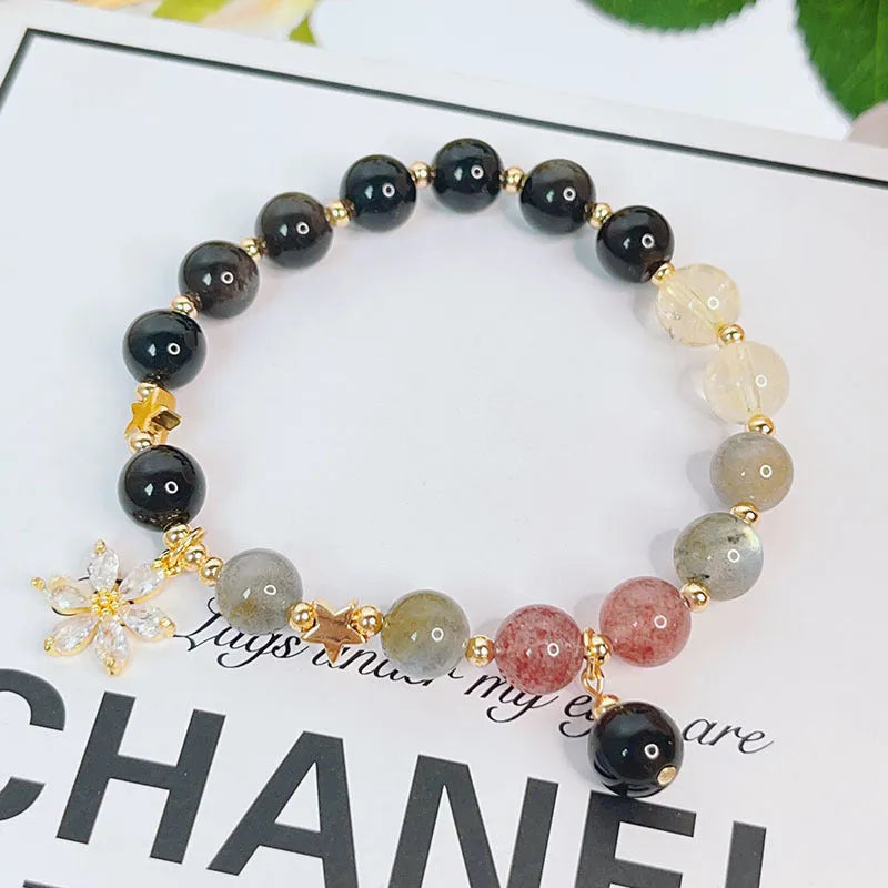 Women's silverstone bracelet with electroplated finish showing floral, love, and star charm designs