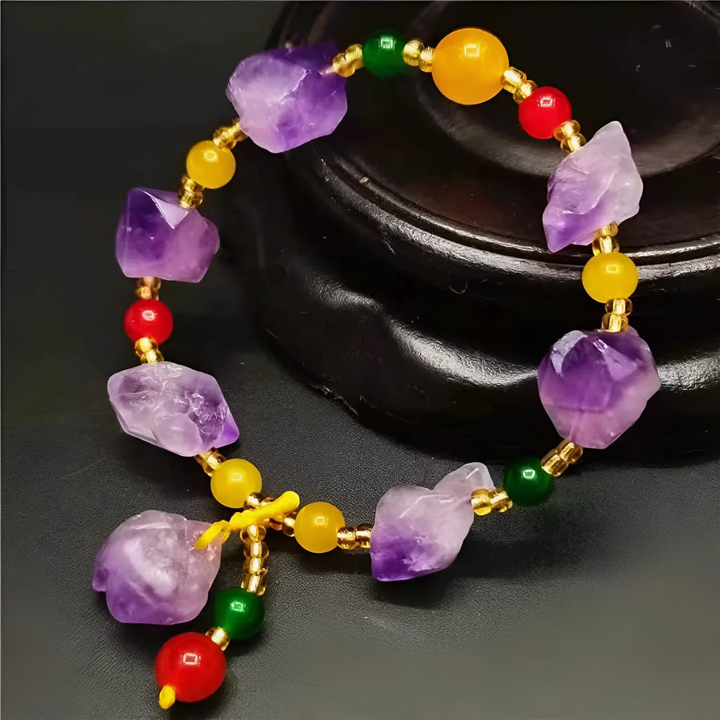 Natural shaped amethyst bead bracelet with a fu character charm on a white background