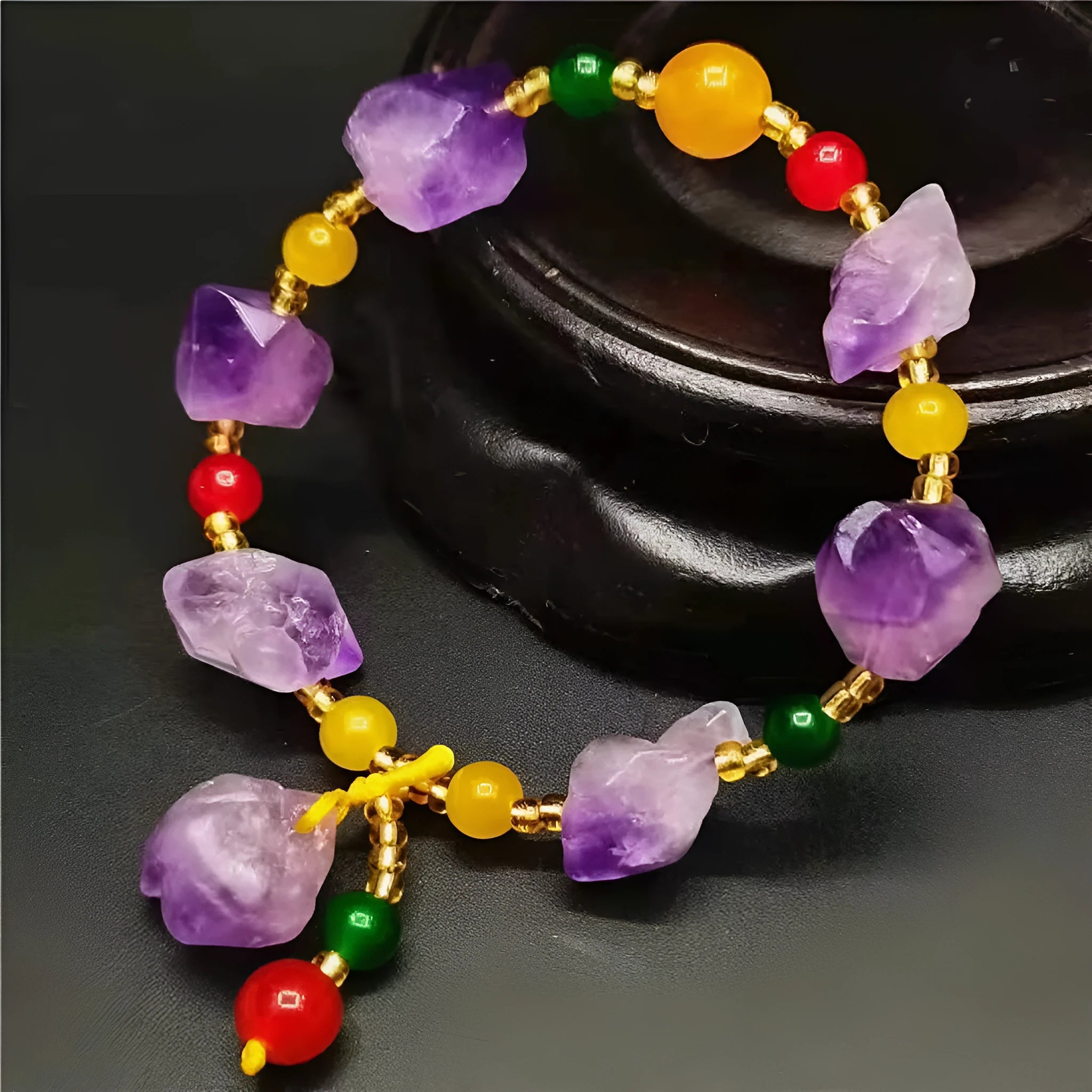 Natural shaped amethyst bead bracelet with a fu character charm on a white background