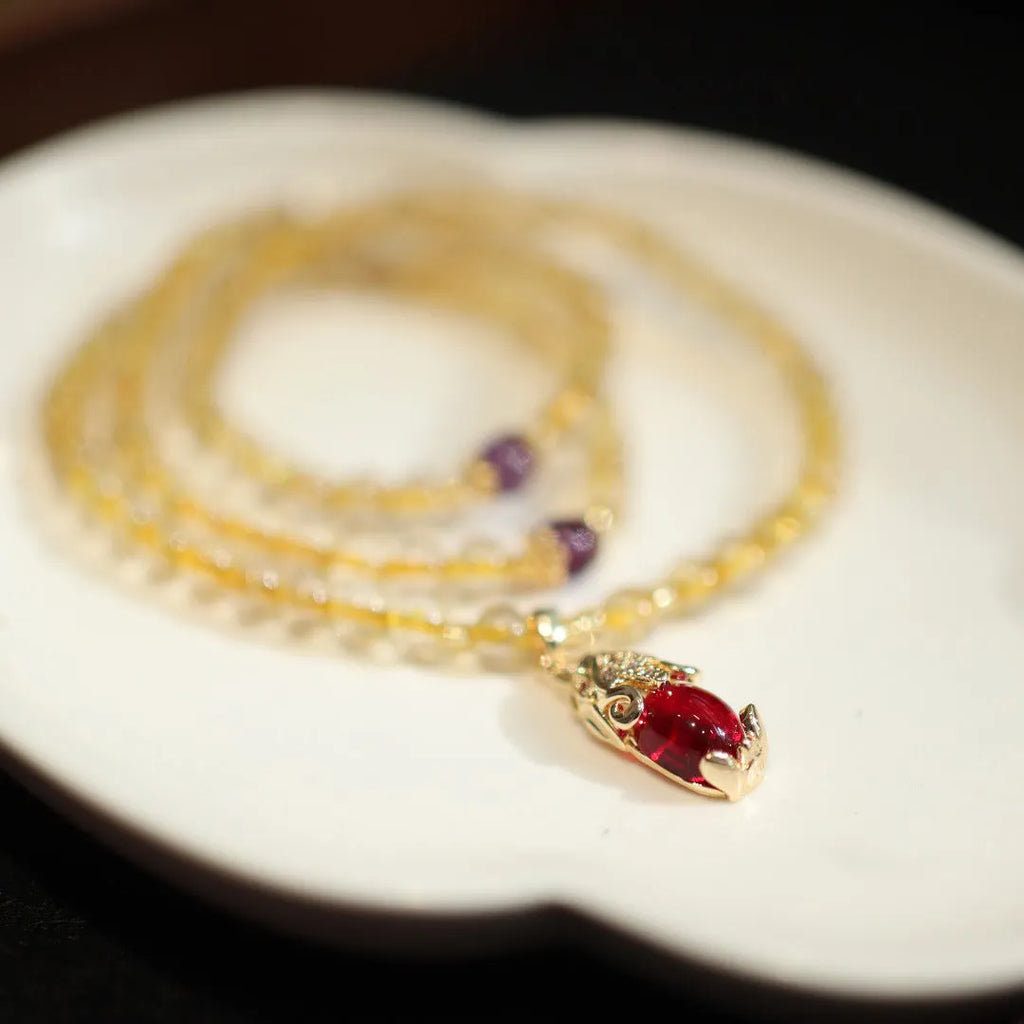 Natural Brazil gold rutilated quartz Chinese style bracelet with three gold rings and chopstick hanging detail.
