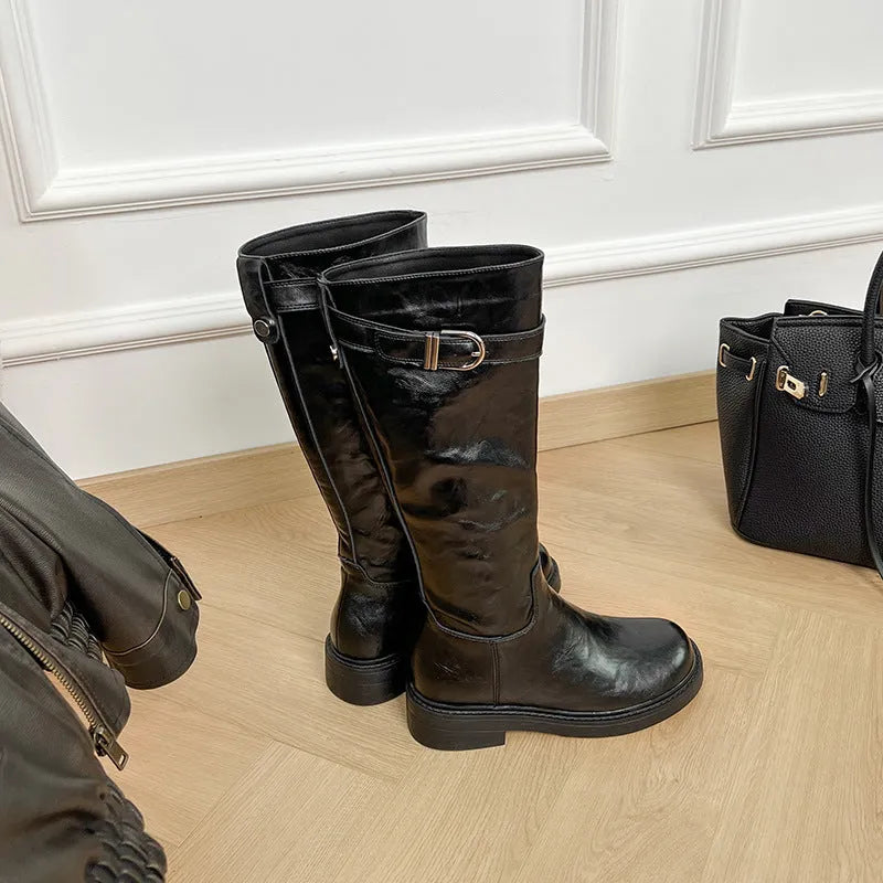 Women's knee-high black retro Martin boots with mid heel and side zipper on a white background