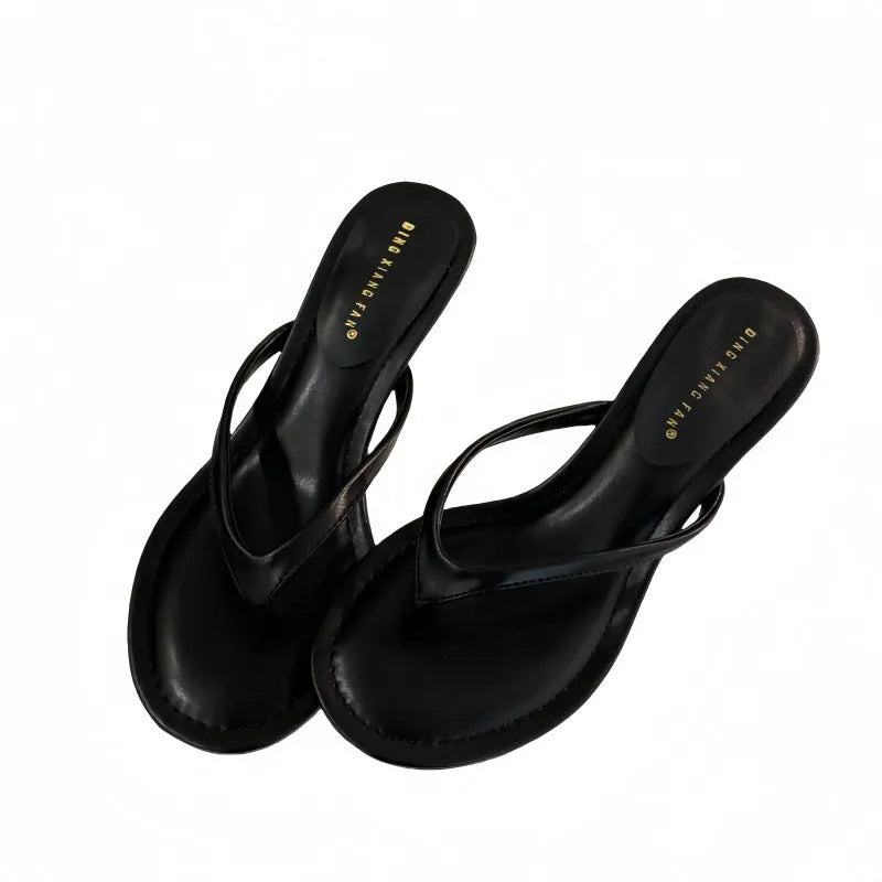 Women's black rubber stiletto sandals with round toe and open-toed design on a white background.