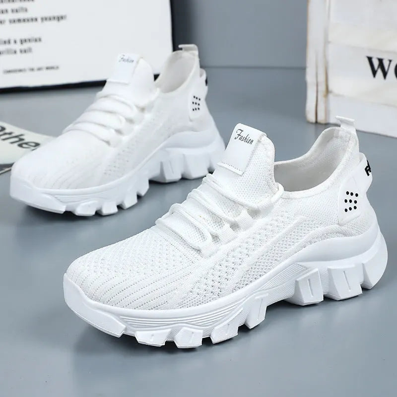 Women's white flyknit running sneaker with thick PVC sole and lace-up front