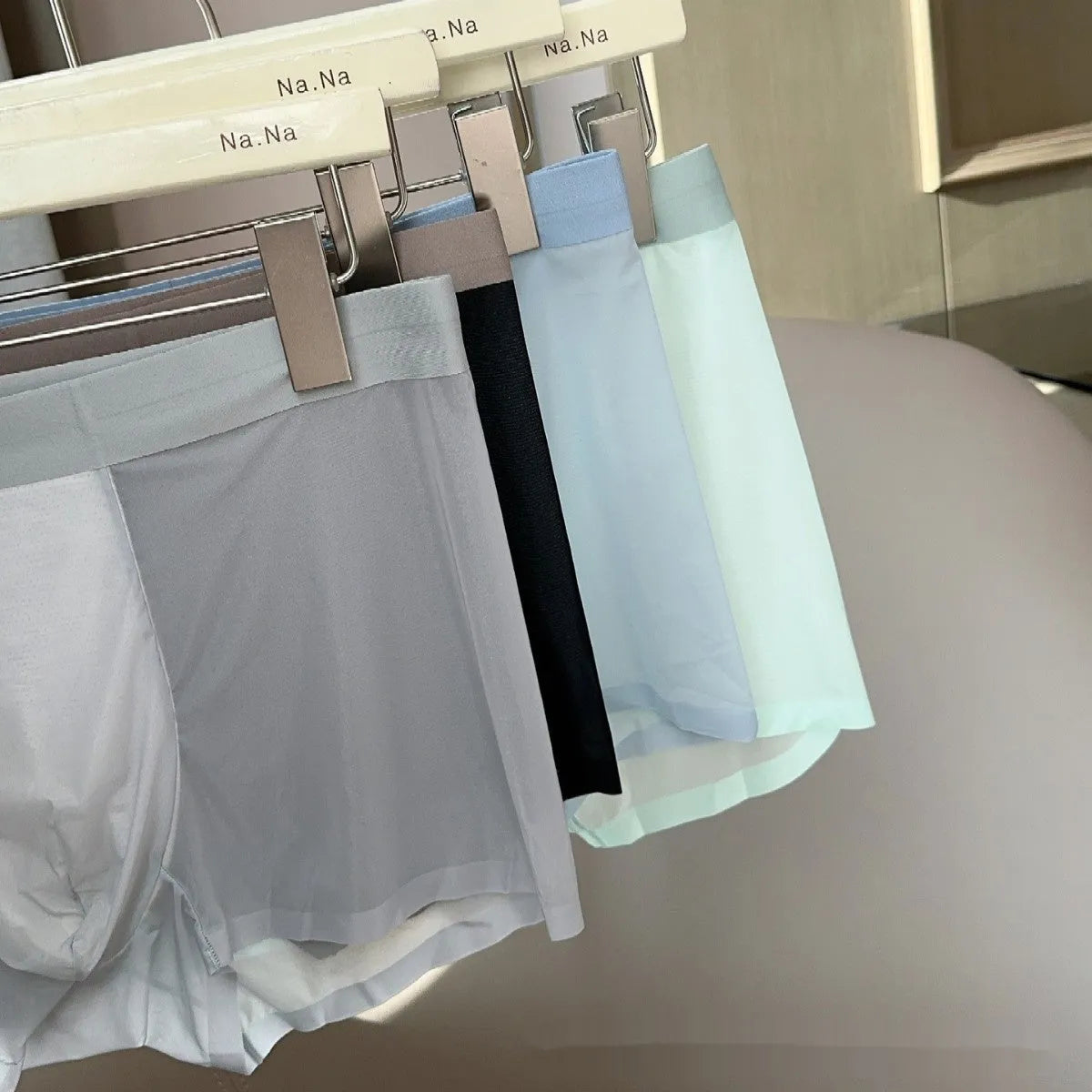 Seamless men's boxer shorts in ice silk fabric showing the honeycomb crotch design and mid-waist fit.