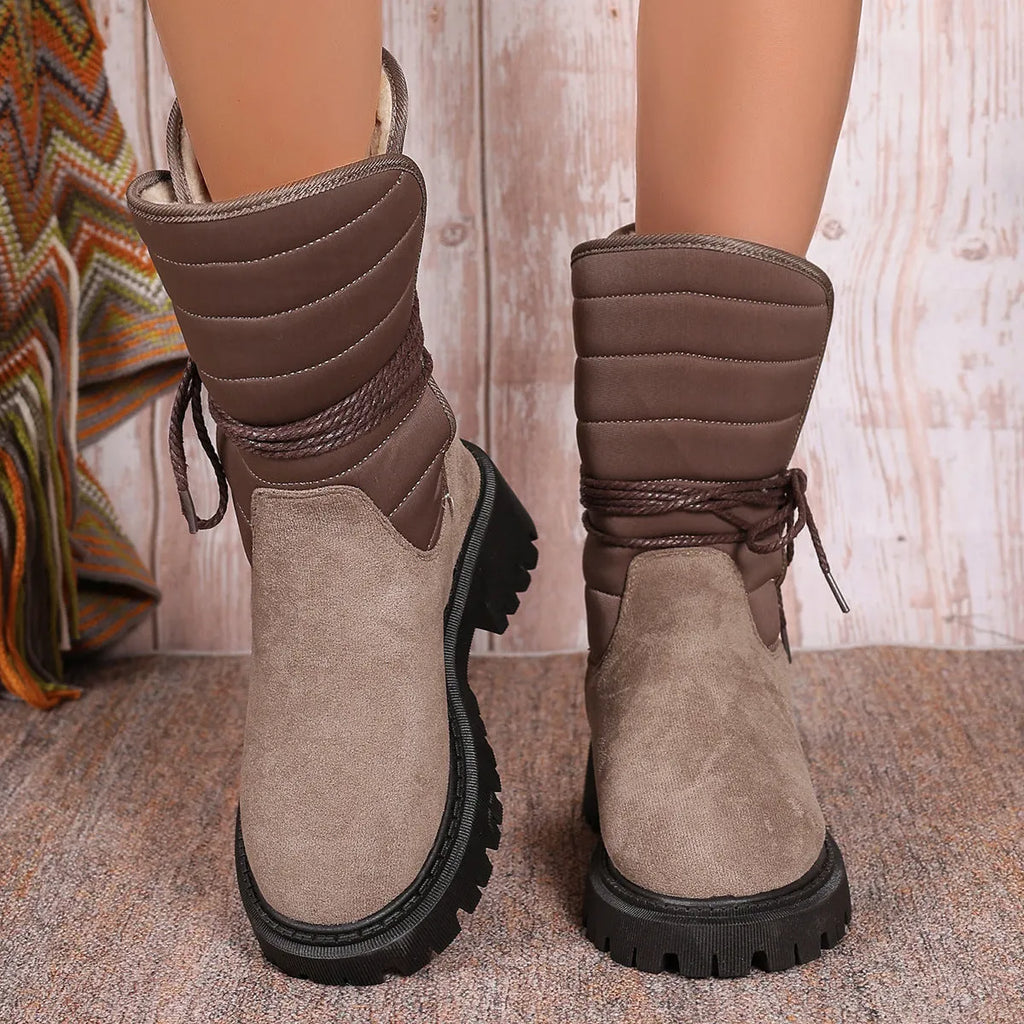 Women's black suede chunky heel snow boots with fleece lining and lace-up design.