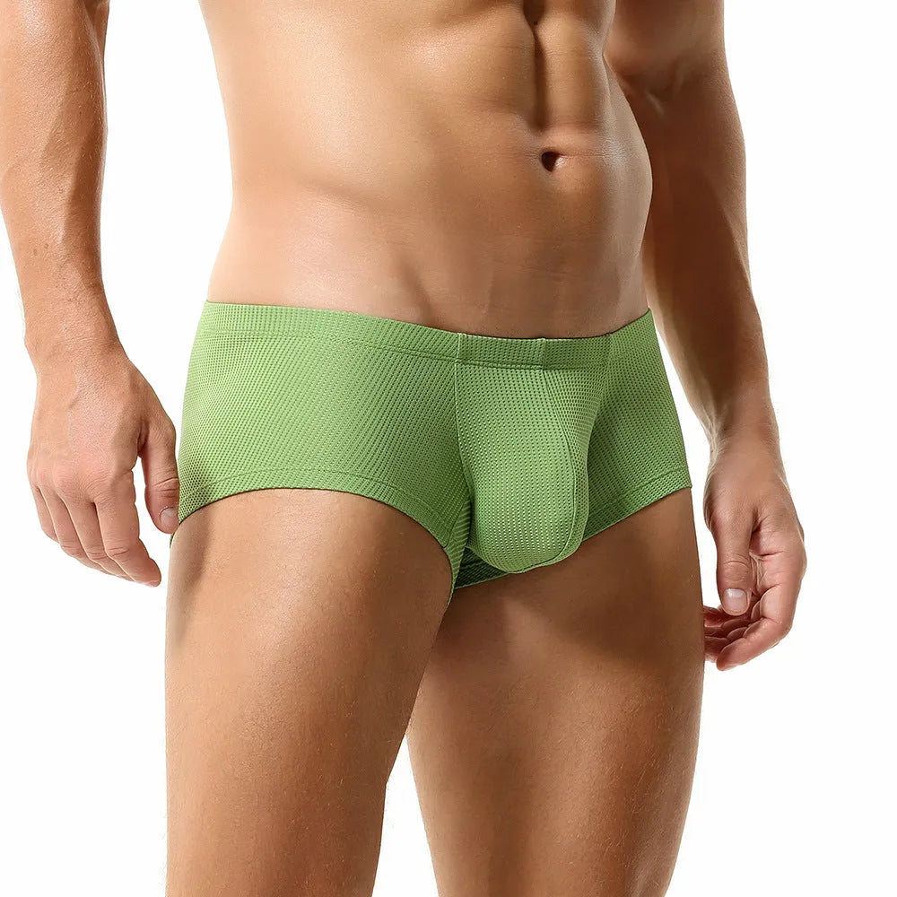 Solid colour men's nylon boxers with a mid-low waist, shown in orange, blue, green, and white.