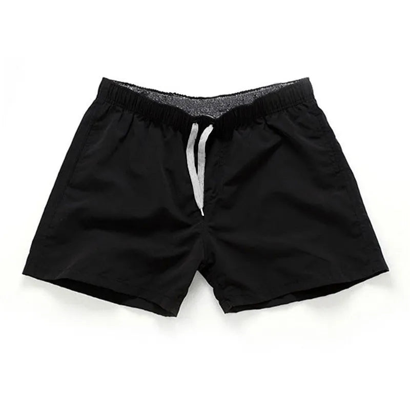 Men's polyester beach shorts in black, shown laid flat, featuring a straight leg opening.