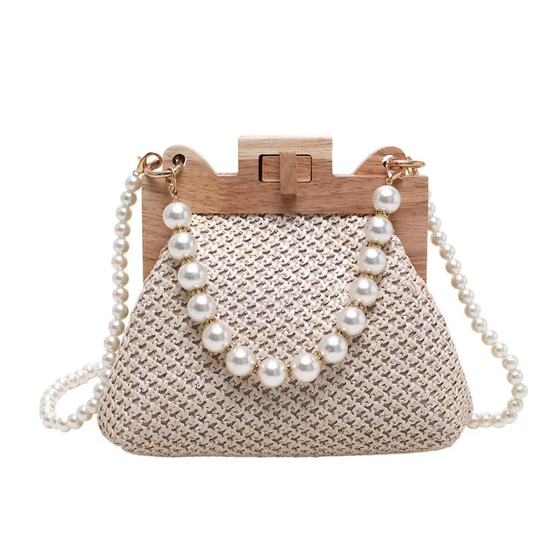 Beige straw woven women's shoulder bag with pearl chain strap showing front view