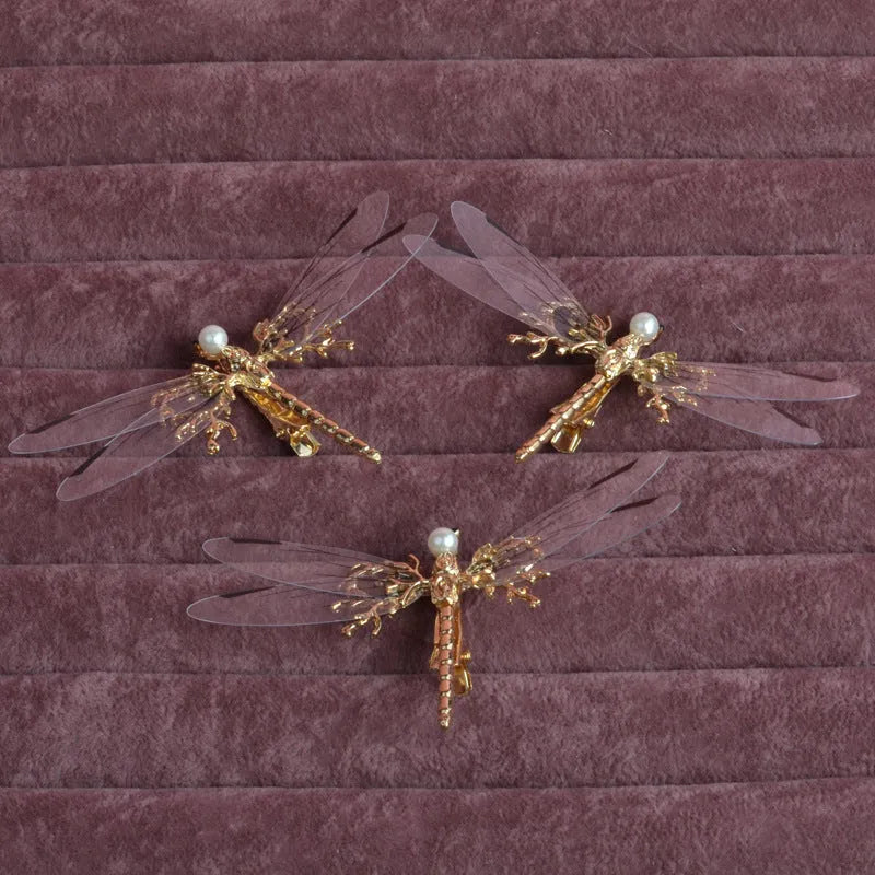 Golden dragonfly-shaped women's hair clip made from alloy with a side fastening.