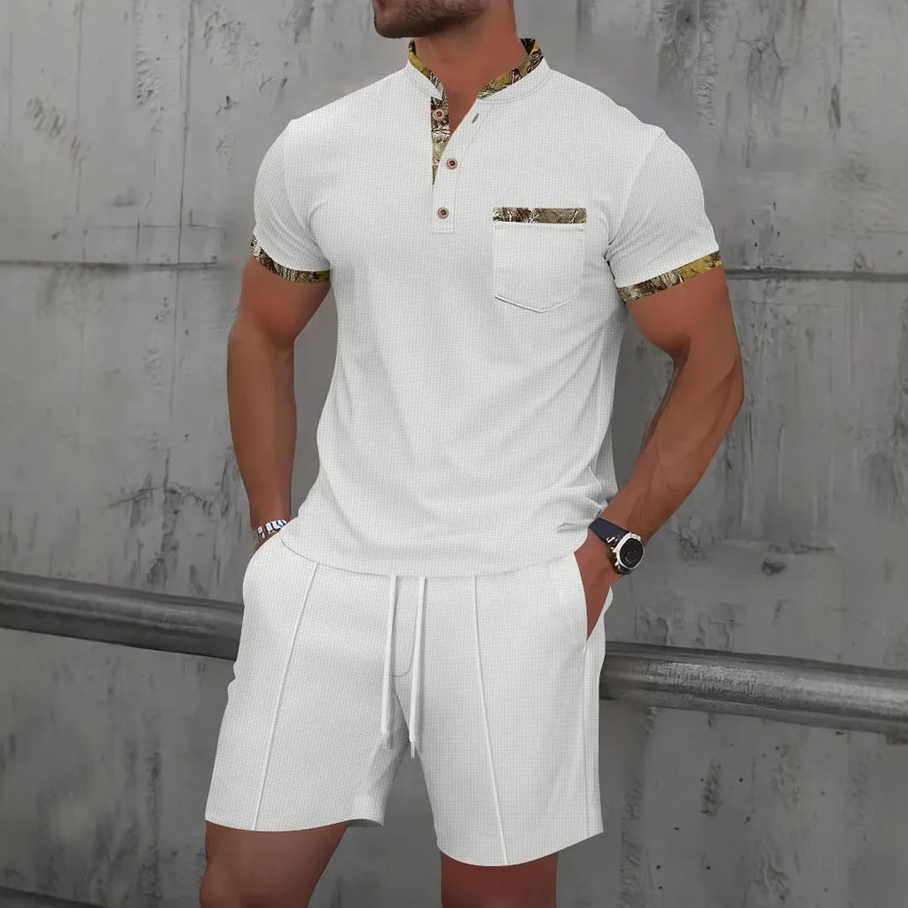 Man modelling a grey waffle knit zip-up polo short sleeve top and matching shorts.