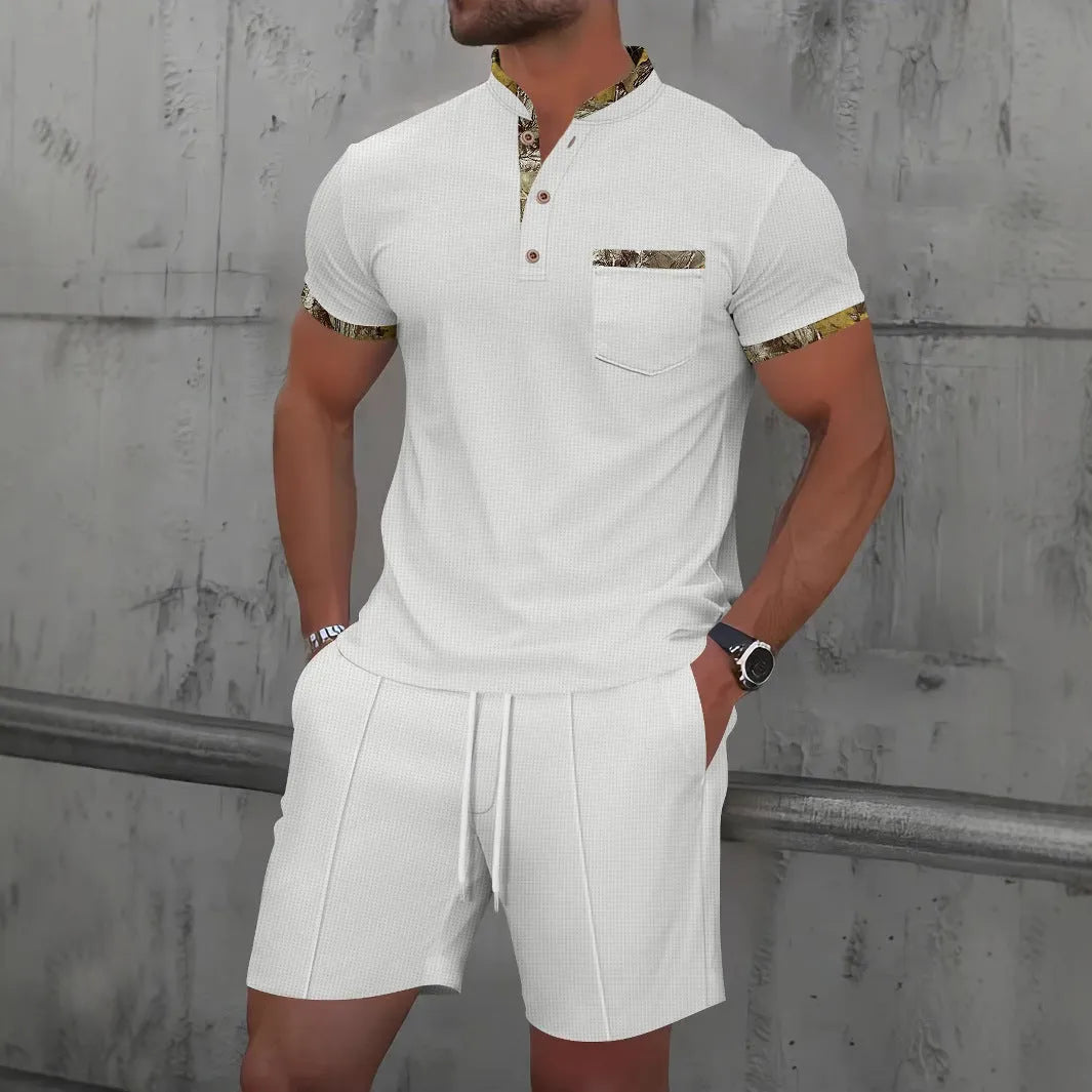Man modelling a grey waffle knit zip-up polo short sleeve top and matching shorts.