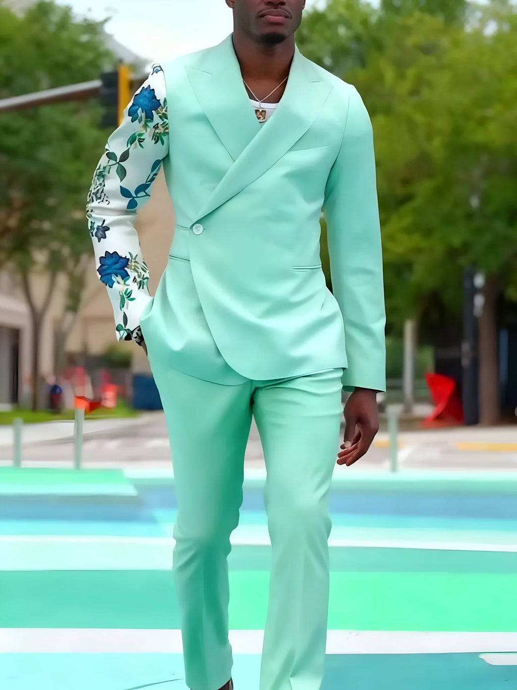 Mint green double-breasted suit set with floral print sleeve and ankle-length trousers.