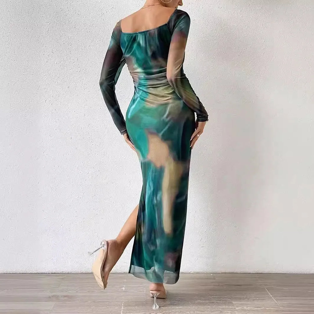 Long green gradient fishtail mesh dress with a square collar and pleated detailing on a mannequin.