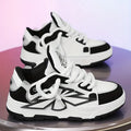 Men's white chunky sneakers with cartoon pattern, thick rubber sole, and lace-up front.