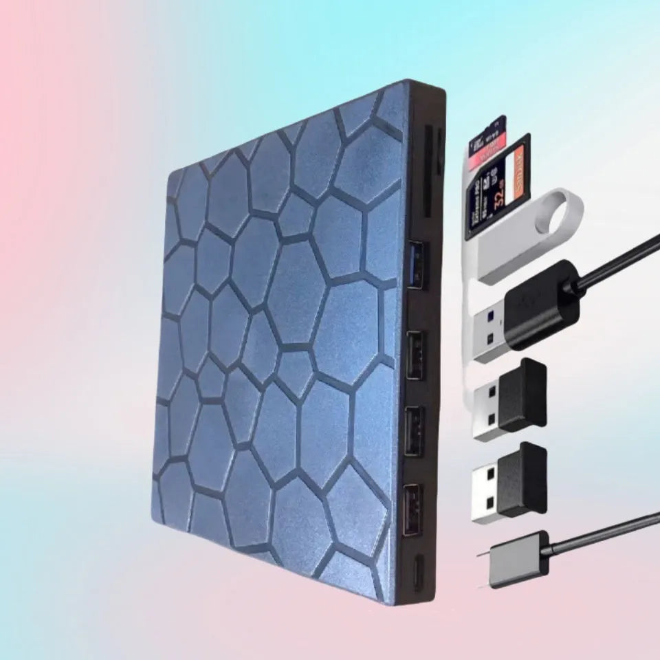 Black aluminium external USB CD drive and writer on a desk next to a laptop.
