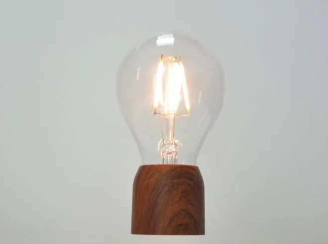 Magnetic levitation floating light bulb on an imitation wood base with multiple international plug options