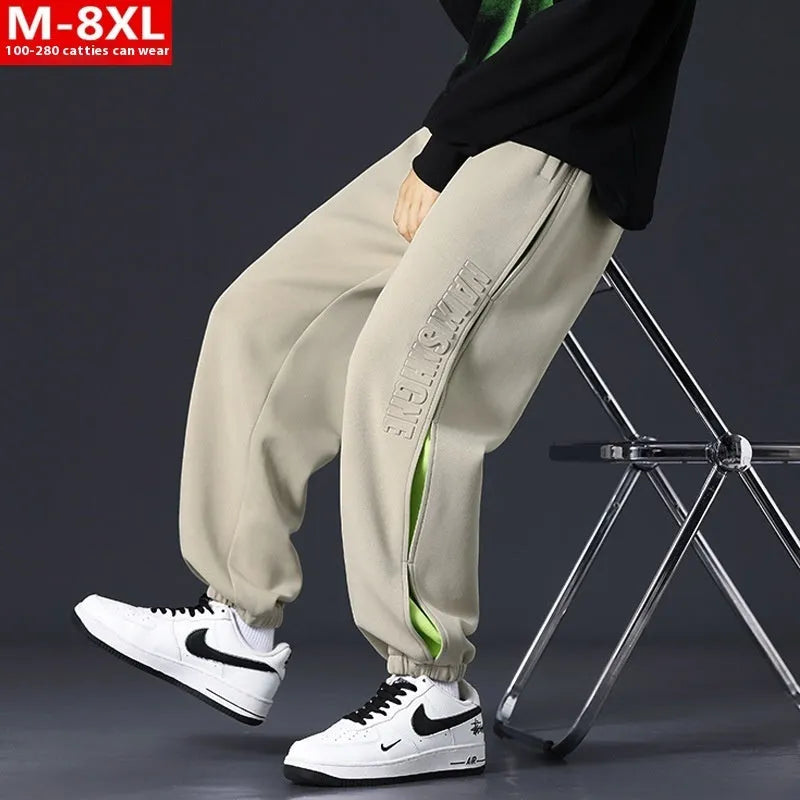 Men's loose-fit cotton trousers with stitching print design and ankle band in grey green.