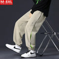 Men's loose-fit cotton trousers with stitching print design and ankle band in grey green.