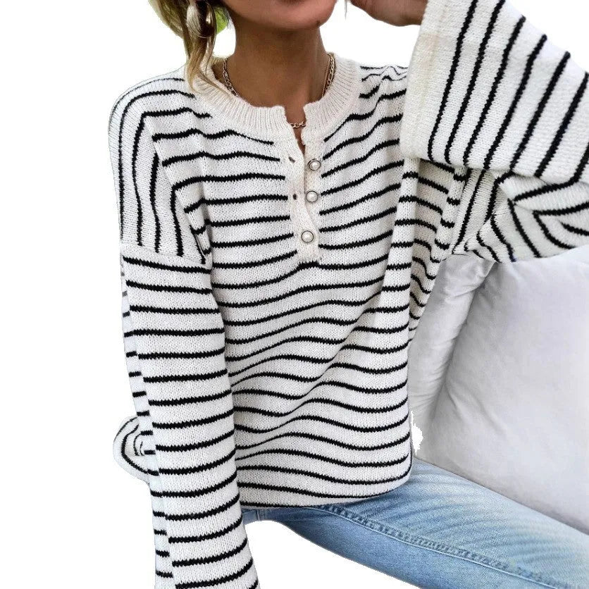 Black striped women's casual top with drop shoulders and button details on viscose knit fabric