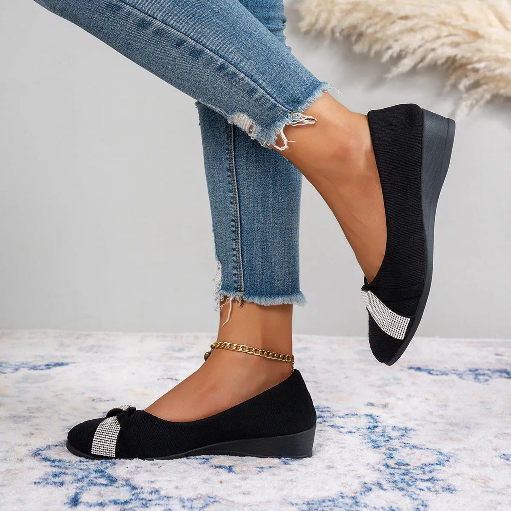 Black women's slip-on casual shoes with rhinestones on fabric upper and a chunky heel.