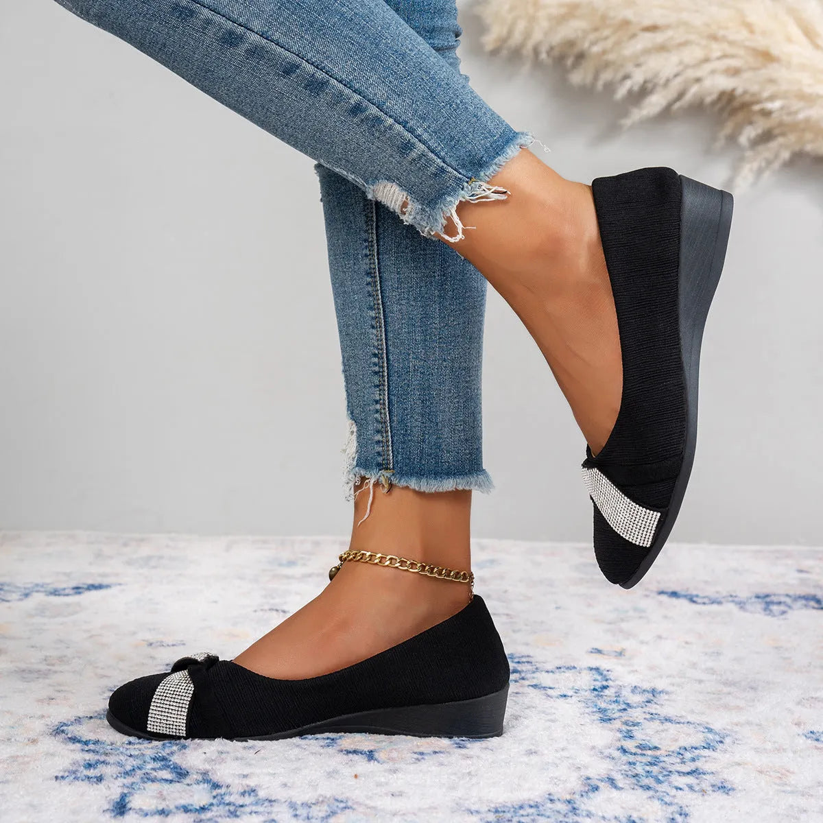 Black women's slip-on casual shoes with rhinestones on fabric upper and a chunky heel.