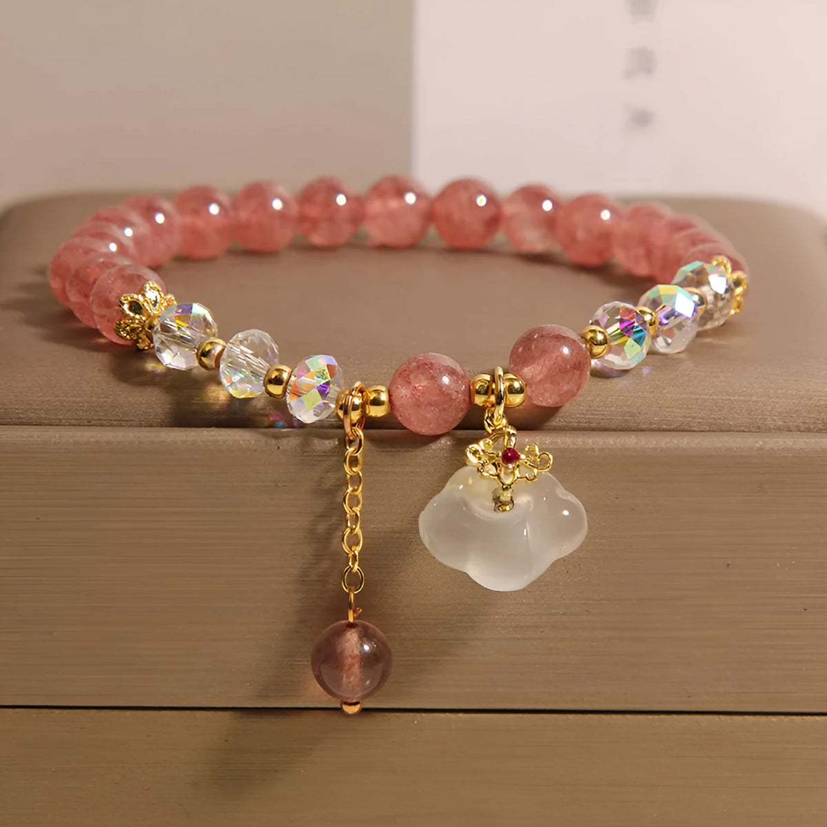 Women's strawberry quartz crystal bracelet with white agate beads and auspicious cloud charms