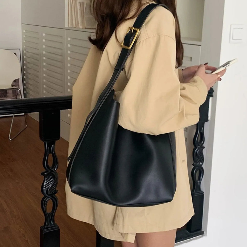 Women's soft PU shoulder bag with swing threads decoration in black and brown colour options