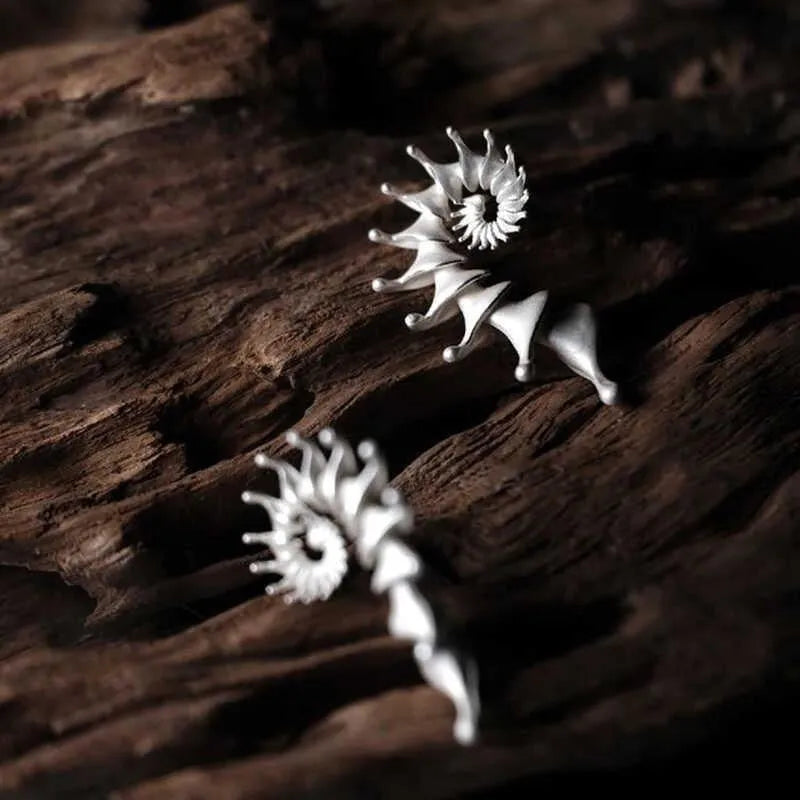 Matte finish conch stud earrings with three-dimensional shaping and irregular design elements