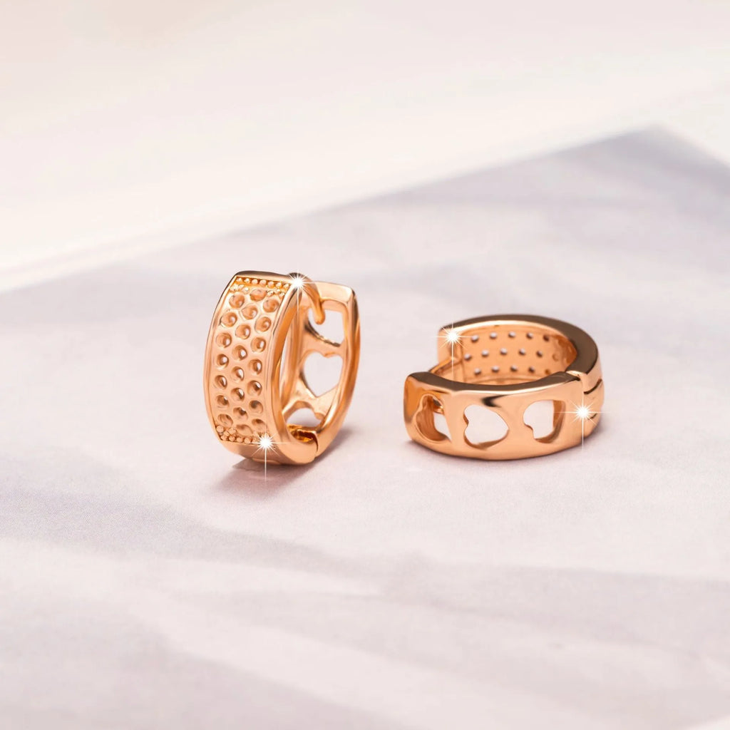 Rose gold electroplated women's earrings with hollowed-out heart design inside circular frame