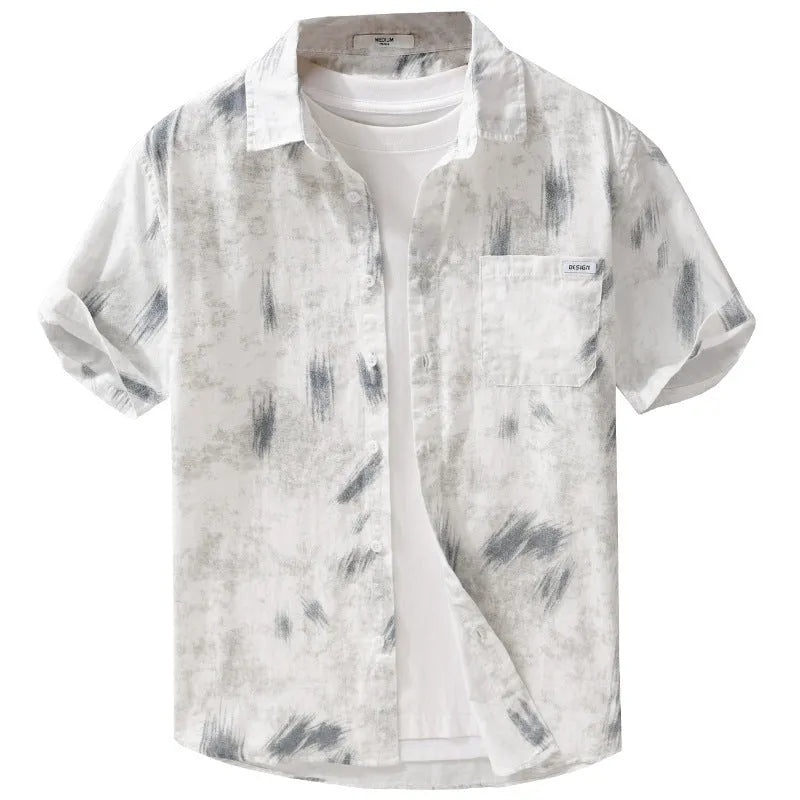 Man wearing a light green, loose-fit short sleeve cardigan with a floral pattern.